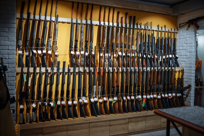 Rows,Of,Rifles,On,The,Wall,,Showcase,In,Gun,Shop