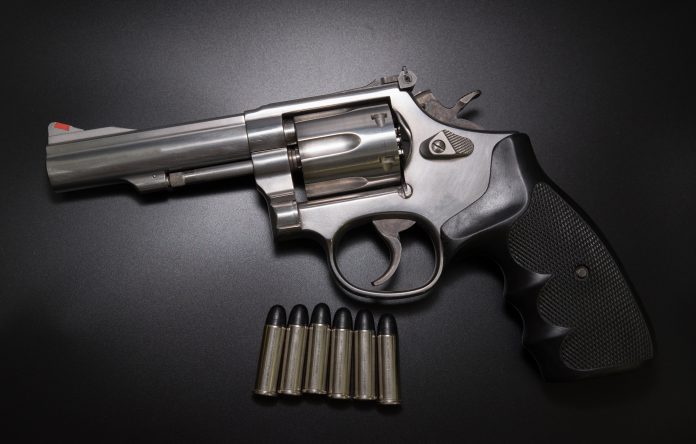 .38,Revolver,With,Caliber,In,Black,Background