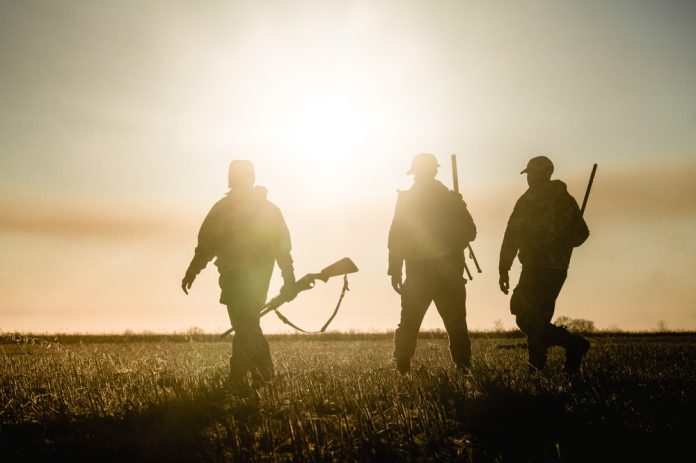 Three,Hunters,On,The,Background,Of,The,Sunset,Are,On