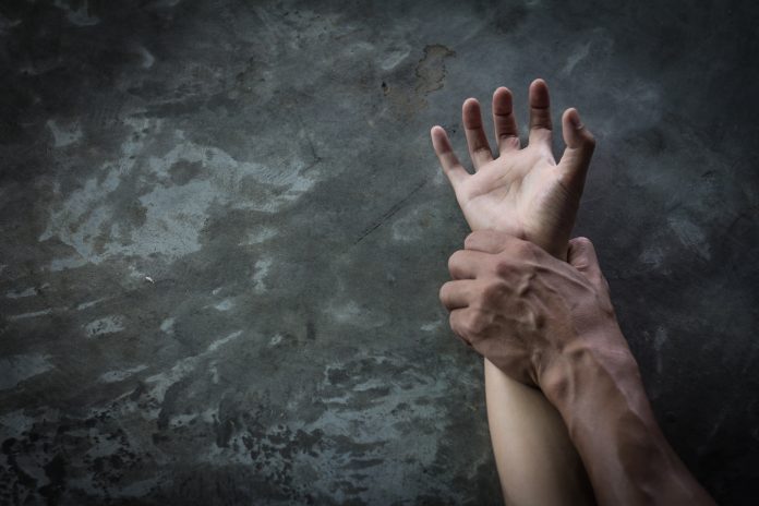 Man's,Hand,Holding,A,Woman,Hand,,Sexual,Abuse,And,Rape