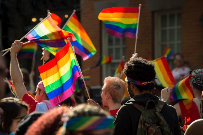 Supporters,Wave,Rainbow,Flags,And,Signs,At,The,Annual,Pride
